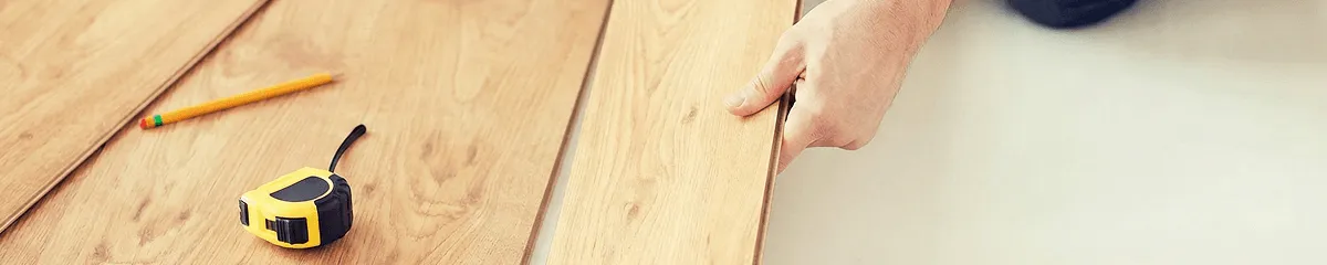 A professional installing wood flooring in Mesa, AZ