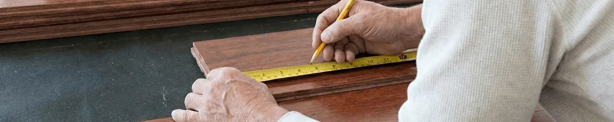 A professional installing wood flooring in Mesa, AZ